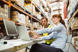 Woman and man purchasing business insurance in their warehouse.